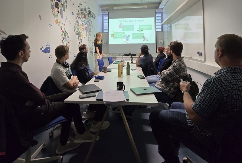 Group members listening to a presentation in a meeting room